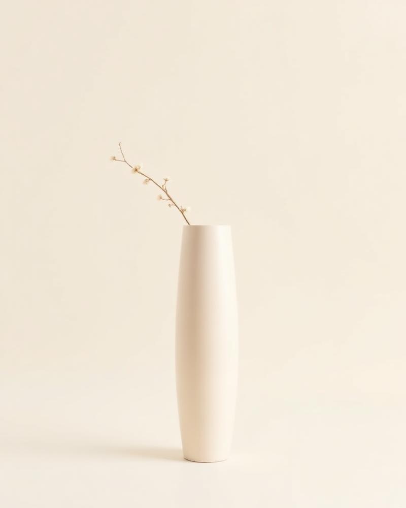 Solstice tall ivory ceramic floor vase holding a single branch